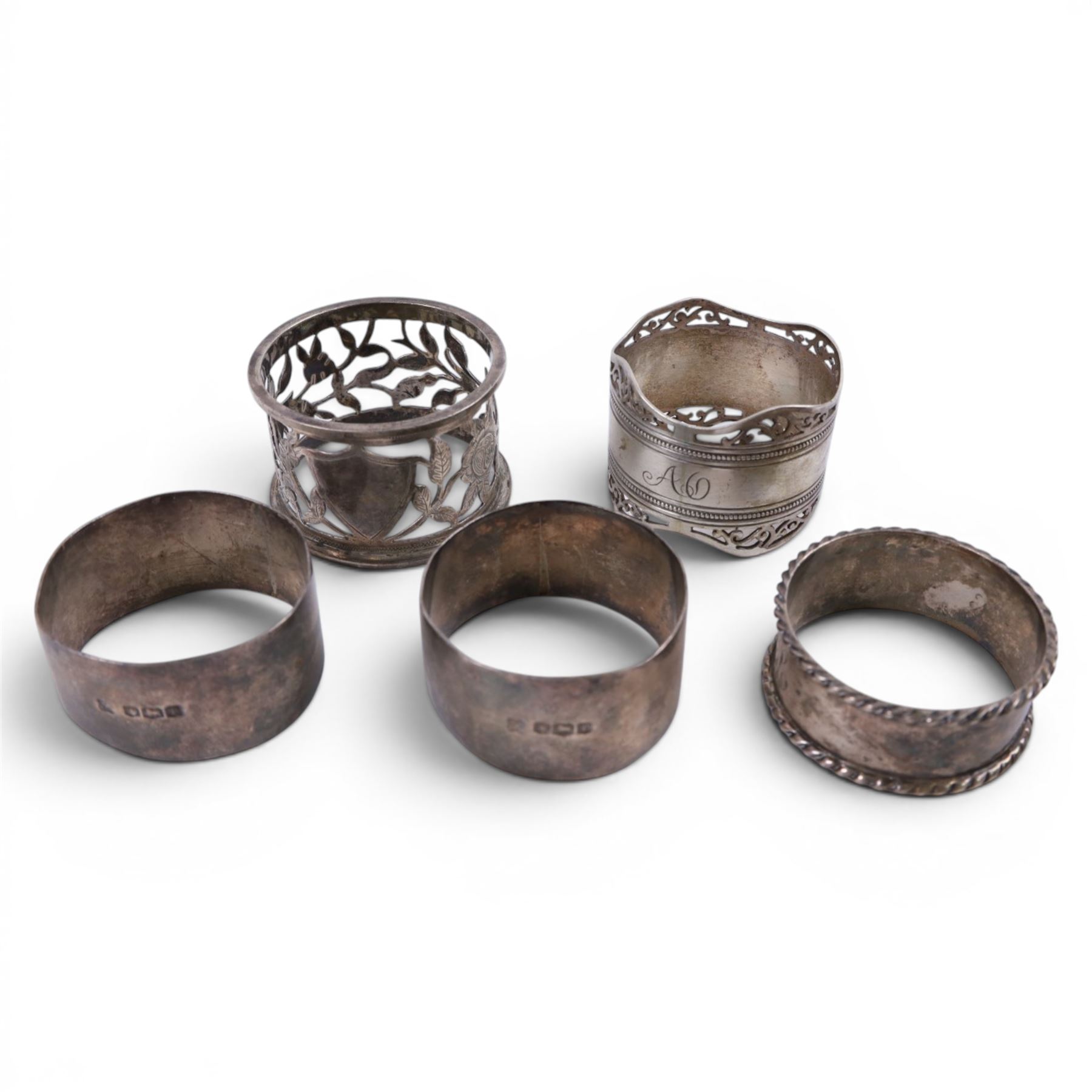 Silver pepper grinder, sifting ladle, silver handled spoon and eight silver napkin rings, all stamped or hallmarked