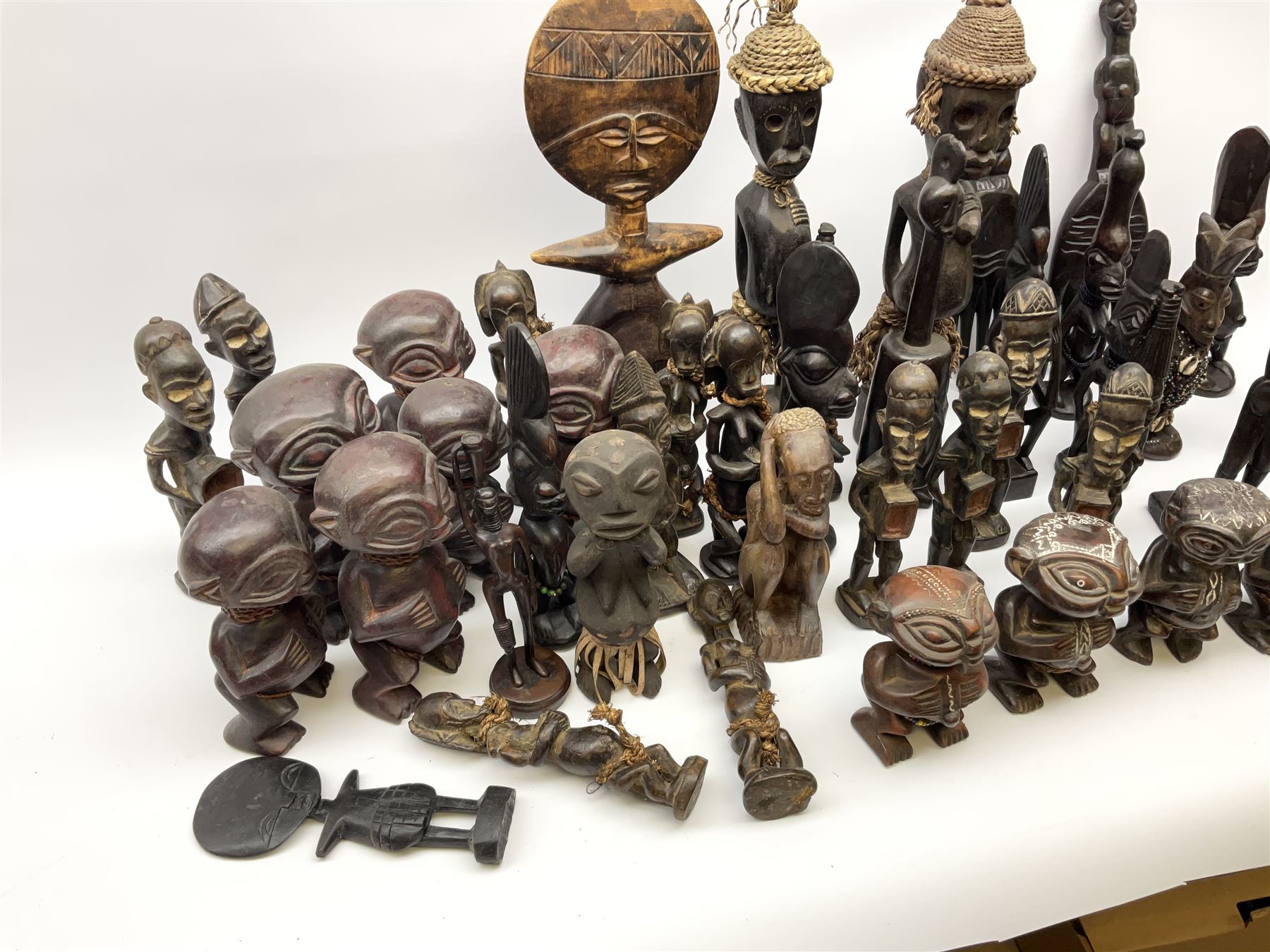 African carved wood figures, various forms and sizes including some with rope decoration, in two boxes