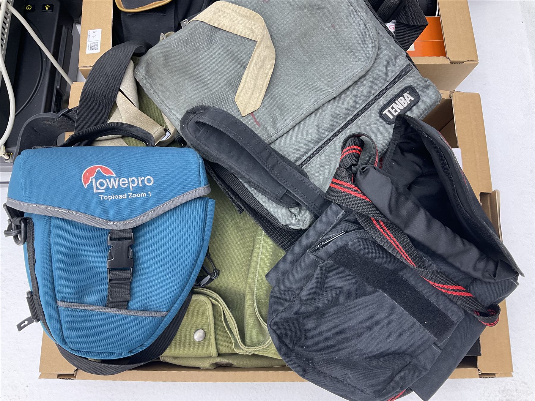 Large quantity of camera equipment in three boxes - Lumix GX1 camera, Canon EOS 500 camera, Lumix FZ100 camera, Pantax  MZ5n, various other cameras, Swift spotting Scope 20 x 60 in box,  Maxtor hard drive, three tripods, Kodak carousel projector, Pradolux slide projector, a selection of camera bags and other camera equipment. 