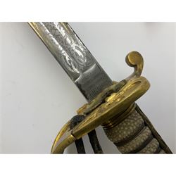 WW1 George V era 1827 Pattern Royal Naval Officer’s sword, the 80cm fullered steel blade decorated with crown, fouled anchor etc and marked Gieves Portsmouth London Edinburgh Devonport to the ricasso, gilded hilt with fouled anchor and crown, wire-bound ray skin grip, lion’s head pommel with mane backstrap, folding/locking langet and full bullion knot; in  leather scabbard having twin brass lockets with hand engraved panels and twin suspension rings L94cm overall. Provenance: By direct family descent from Brian Heathcote HMS Conqueror later Superintendant in the Liverpool Special Constabulary.