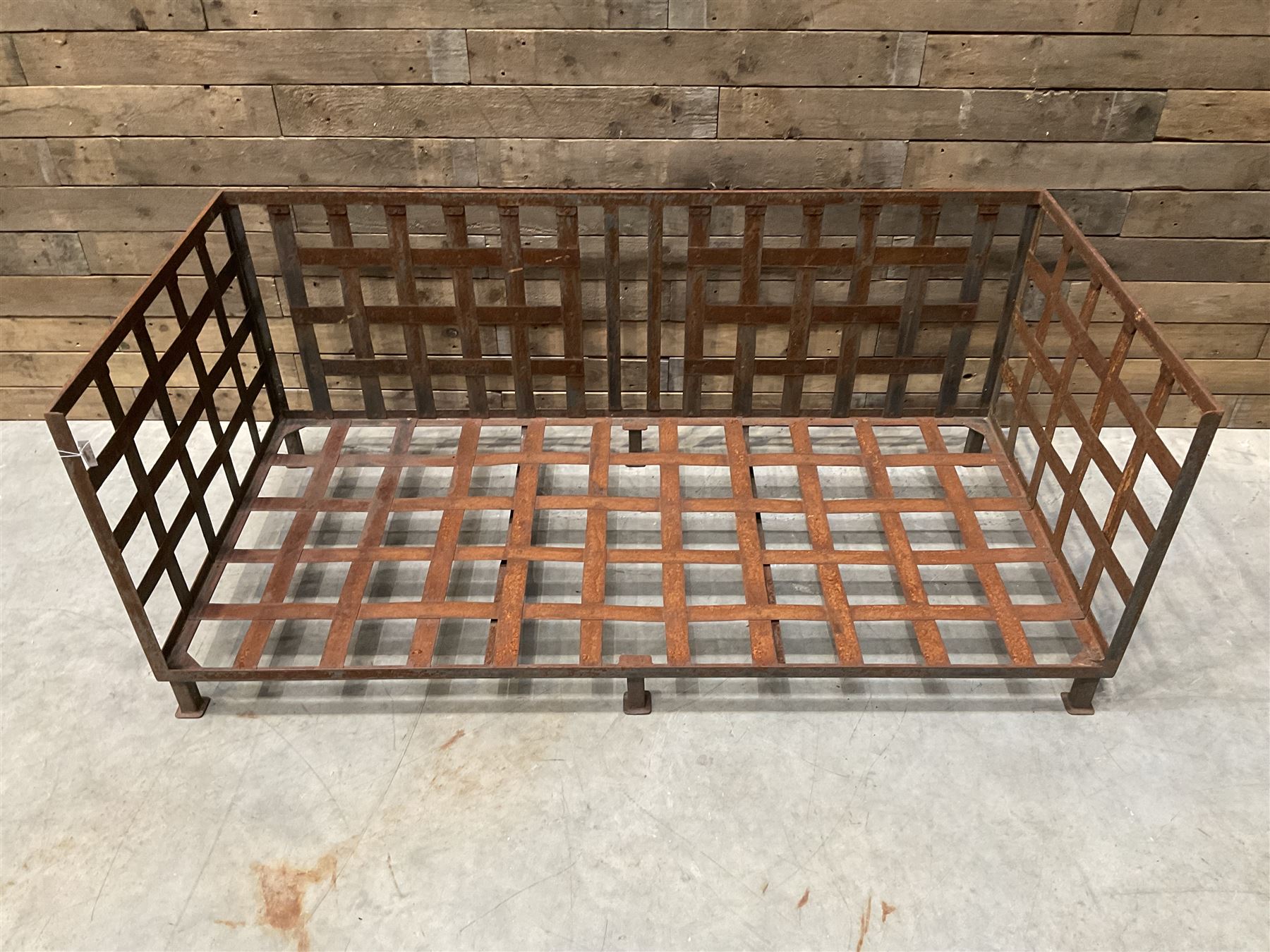 Wrought iron strapwork garden day bed, lattice back and sides