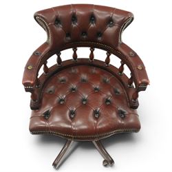 Georgian design captains swivel desk chair, rolled cresting rail over open spindle back on tripod base, upholstered in buttoned oxblood leather