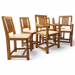 Mouseman - set of six (4+2) oak dining chairs, pierced and carved lattice back over leather upholstered seat, on octagonal front supports united by stretchers, carved with mouse signature, by the workshop of Robert Thompson, Kilburn