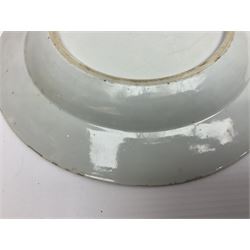 Three 18th century Chinese Famille Rose plates, the first example enamelled with blossoming peonies, rockwork and fence, the other two examples of similar design, decorated with blossoming peonies and sprigs within shaped inner borders, each approximately D23cm