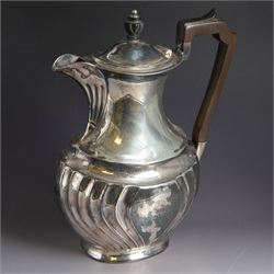 Late Victorian silver hot water pot, of oval part fluted form, with wooden handle and fini...