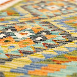 Two Chobi flatweave kilim runners with a repeating stepped diamond medallion design in live green, rust, teal, purple, and ivory, framed by chevron and geometric borders, (2)