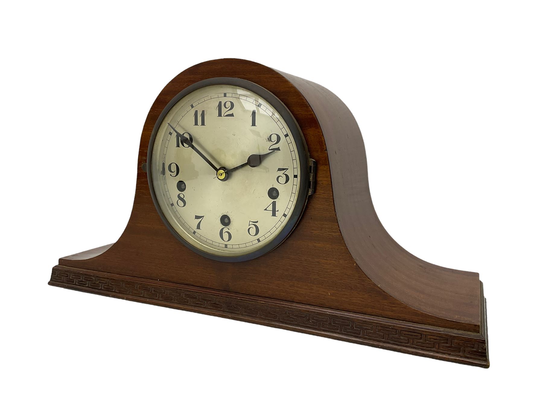 Sapele Mahogany cased tambour mantle clock c1950 with a three-train chiming movement, chiming the quarters on 5 gong rods, with a silvered dial, Arabic numerals, minute track and steel spade hands, strike/silent facility. With pendulum.



