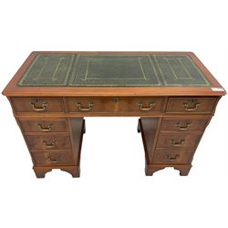 Georgian design yew wood twin pedestal desk, rectangular top with green leather inset writing surface, fitted with nine cock-beaded drawers, on bracket feet