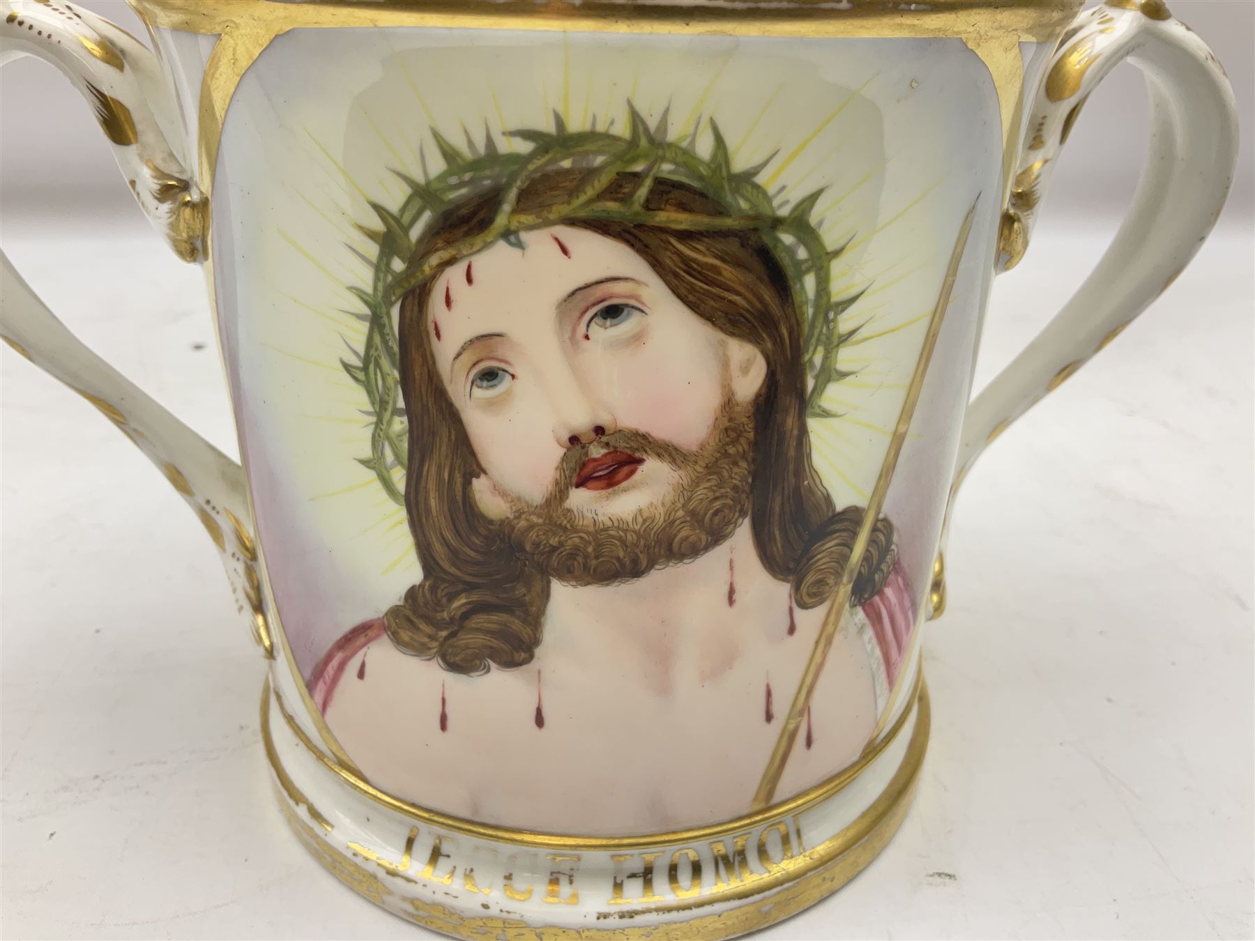 19th century loving cup, with decorated with religious iconography, a gilt rim and writing 'Henry Whittirld Wolverhampton, Whoever drinketh of the water shall thirst again but who soever drinketh of the water that i shall give him shall never thirst',  H14cm