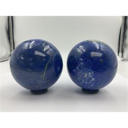Pair of Lapis lazuli spheres, upon a carved stone stands, D8cm