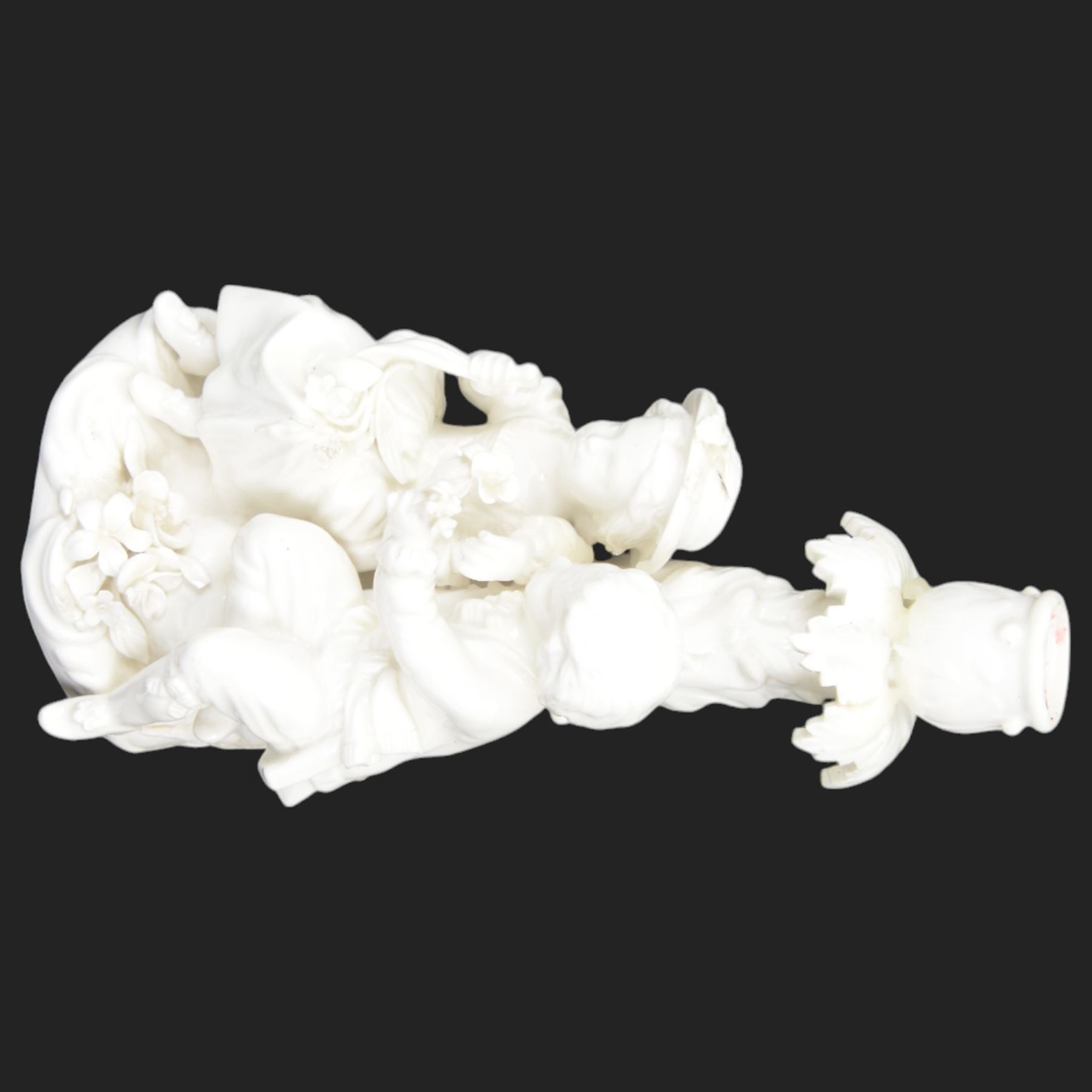 Pair of 19th century Meissen style Blanc de Chine figural candlesticks, each depicting children gathering flowers, with spurious mark beneath, H21cm