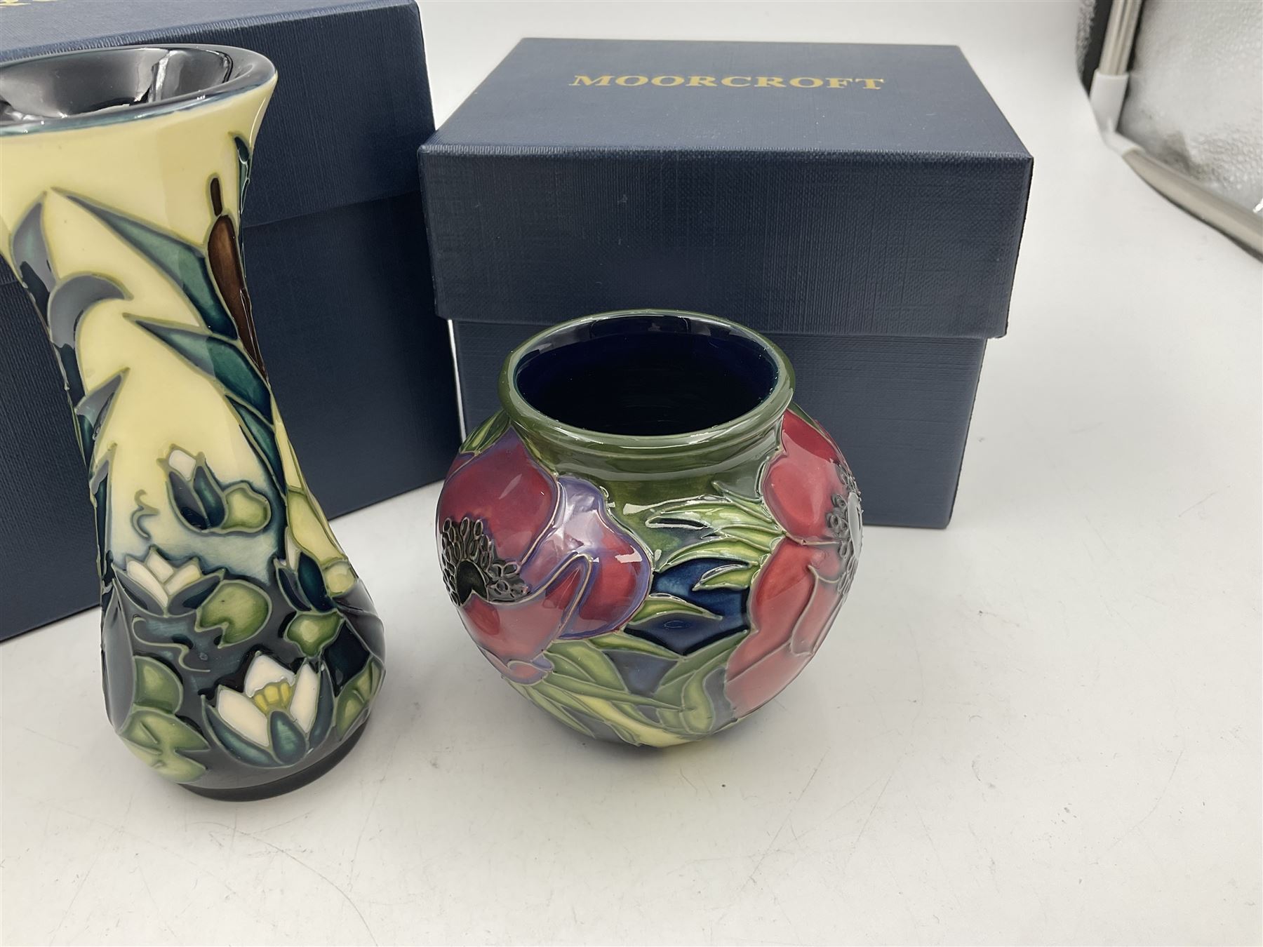 Two small Moorcroft vases, one decorated in the Lamia pattern by Rachel Bison, circa 1995, H13cm and the other in the Anemone Tribute pattern by Emma Bossons, circa 2002, H7.5cm, both with original boxes (2)