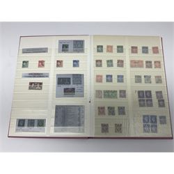 Mostly Great British stamps, including King Edward VII two shillings and sixpence, five shillings and ten shillings, King George V seahorses, King George VI high values, Queen Elizabeth II pre and post decimal etc, housed in a pink stockbook 