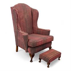 Late 20th century Georgian style wingback armchair with matching footstool, upholstered in...