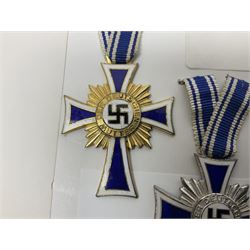 WWII set of three German Mother's Crosses, 1st Class in gilt, 2nd Class in silver and 3rd Class in bronze; all with ribbons (3)