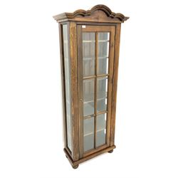 Stained wood display cabinet, shaped and moulded top, panelled glazed door enclosing six shelves, raised on turned supports 