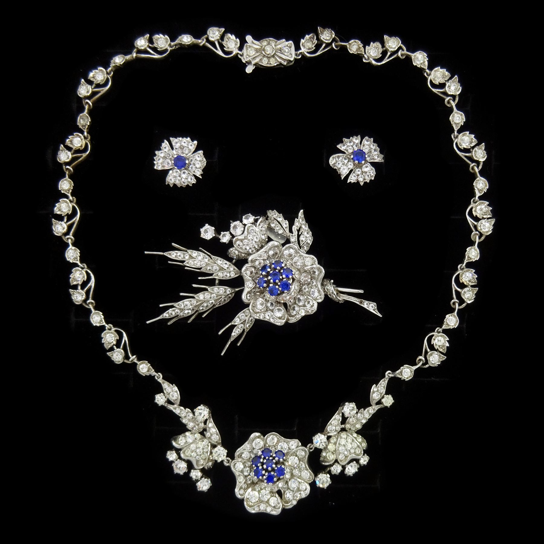 Silver synthetic sapphire and white paste stone set flower necklace, brooch and matching pair of earrings, stamped sterling
