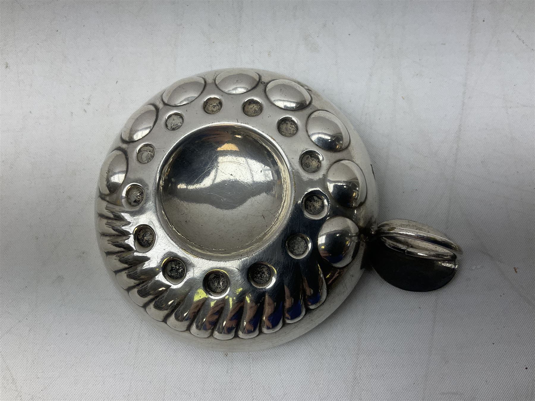 French silver plated wine taster of typical form, stamped, together with a silver plated napkin ring, and an 'Alpaca Silver' pill box with mother of pearl detailed cover, (3)