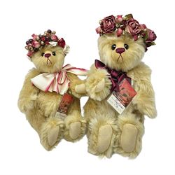 The Cotswold Bear Company - two teddy bears from ‘The Flower Collection’ comprising ‘Mayflower’ no.99/100, blonde mohair with dark pink flower crown and bow, H33cm; ‘Phoenix’ no. 99/100, blonde mohair with white and red rose flower crown and bow, H28cm; both with original labels and purchase receipt (2)