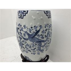Pair of Chinese blue and white garden seats, each of barrel form, decorated with dragon and phoenix amidst flowering vines, each upon a hardwood stand with five curved legs, seats H45cm D29cm including stand H68cm