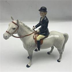 Beswick hunting group, comprising huntswoman on grey horse no 1730, huntsman on brown horse no 1501, fox figure no 1440 and eight fox hounds, all with printed marks beneath (11)