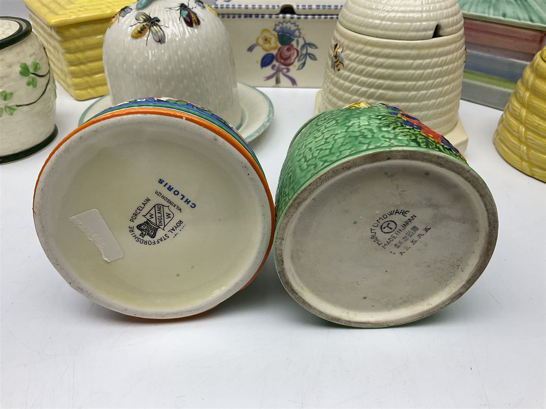 Clarice Cliff for Wilkinson Ltd Crocus Bizarre beehive honeypot painted in the Crocus pattern, together with two beehive Beswick honey pots, Poole square honey pot etc (14)