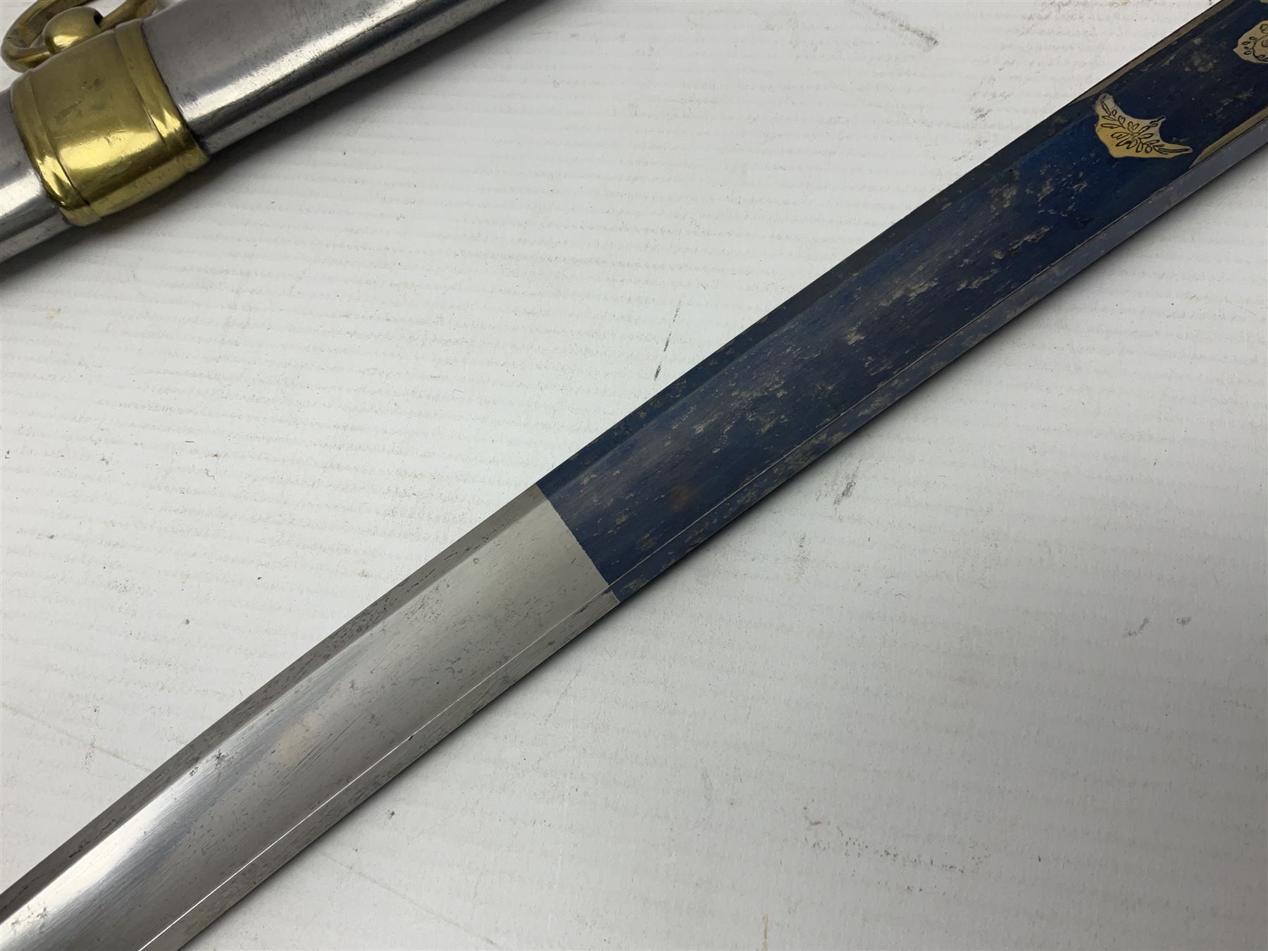 Early 19th century French Lancers officer's sword c1810, the 84cm curving fullered blade retaining most of its bluing, gilding and engraved decoration, inscribed I.S.& C. to ricasso (for Schimelbusch), brass three-bar hilt with elongated elliptical langets and wire-bound leather grip; in polished steel scabbard with two brass suspension rings L100cm overall