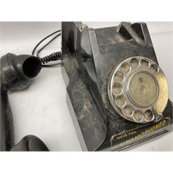 Two black bakelite rotary telephones, with chrome dialling wheels, to include example with 'Call Exchange' plaque to front