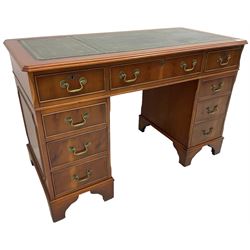 Georgian design yew wood twin pedestal desk, rectangular top with green leather inset writing surface, fitted with nine cock-beaded drawers, on bracket feet