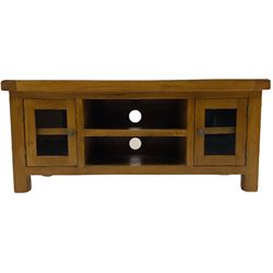 Medium oak entertainment unit, fitted with two glazed cupboards and open console shelves