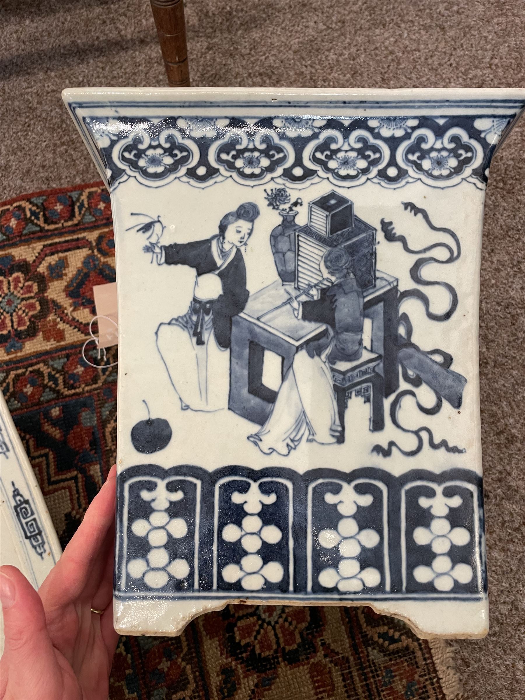 19th century Chinese blue and white planter and stand, each of square slightly tapering and flared form, the planter decorated with figures and precious objects between stylised foliate borders, the stand decorated with landscapes beneath a lipped rim with cell band, planter H28cm D25.5cm, stand H7cm D26cm