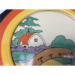 Clarice Cliff Bizarre for Newport Pottery Orange Roof Cottage pattern plate, circa 1932, hand painted with a stylised cottage and bridge landscape with yellow, orange and black banding, black printed mark beneath, D22cm 