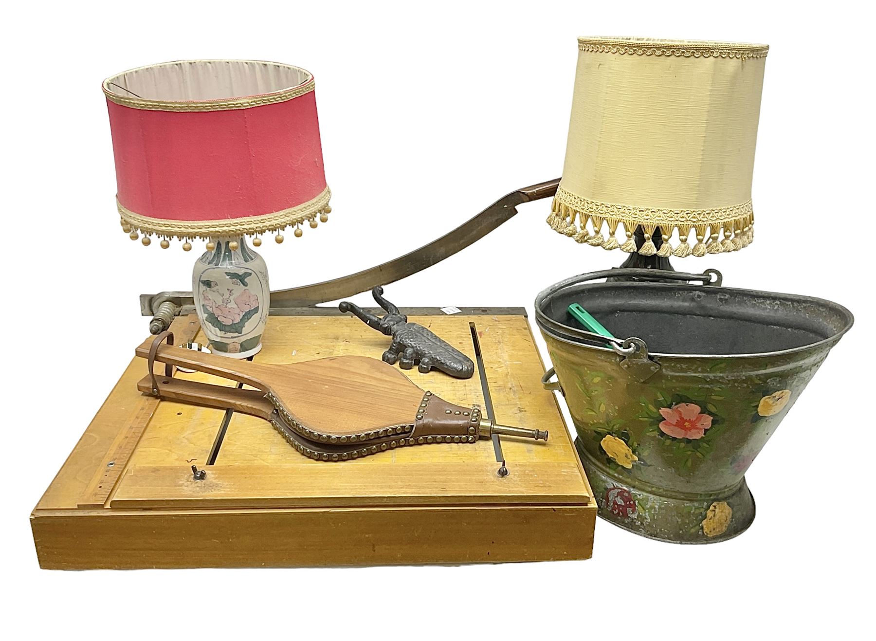 Coal bucket painted with flowers together with pair of bellows, boot scraper in the form of a beetle, wooden guillotine, composite table lamp with tassel lampshade and one other