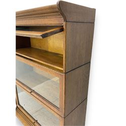 Early 20th century oak three-tier stacking library bookcase, enclosed by hinged and sliding glazed doors