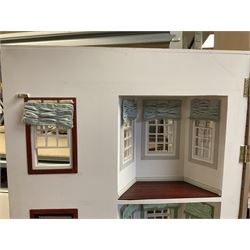 'The Hollies' - good quality sectional wooden doll's house in the form of a Georgian style four-storey bay windowed town house with simulated brick front elevation, rendered sides, off-set corner stonework, faux slate-hung top floor with flat roof and chimney stack, working sash windows, iron railings around front basement courtyard with hinged front elevation to two rooms with  spiral staircase, side hinged central section approached by external steps with iron balustrades to the sides leading to a front door, entrance hall with stairs to landing and two rooms on two floors with dado panelling and fire-surrounds, the top floor with top hung front elevation revealing stairs to a landing and bedroom; wired for electricity L51cm D65cm H107cm including chimney; together with a good quantity of quality wooden furniture and accessories including piano, dressers, bookcase and books, rugs, double half-tester bed, metalware, pictures etc