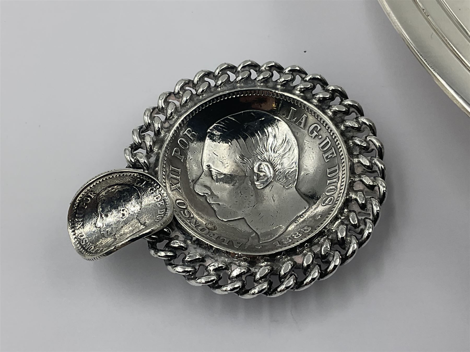 Spanish silver coin dish, with white metal chain rim and upon three ball feet, together with a silver plated armada style dish, with cast racehorse and jockey to centre, coin dish D4.8cm, armada dish D20.5cm