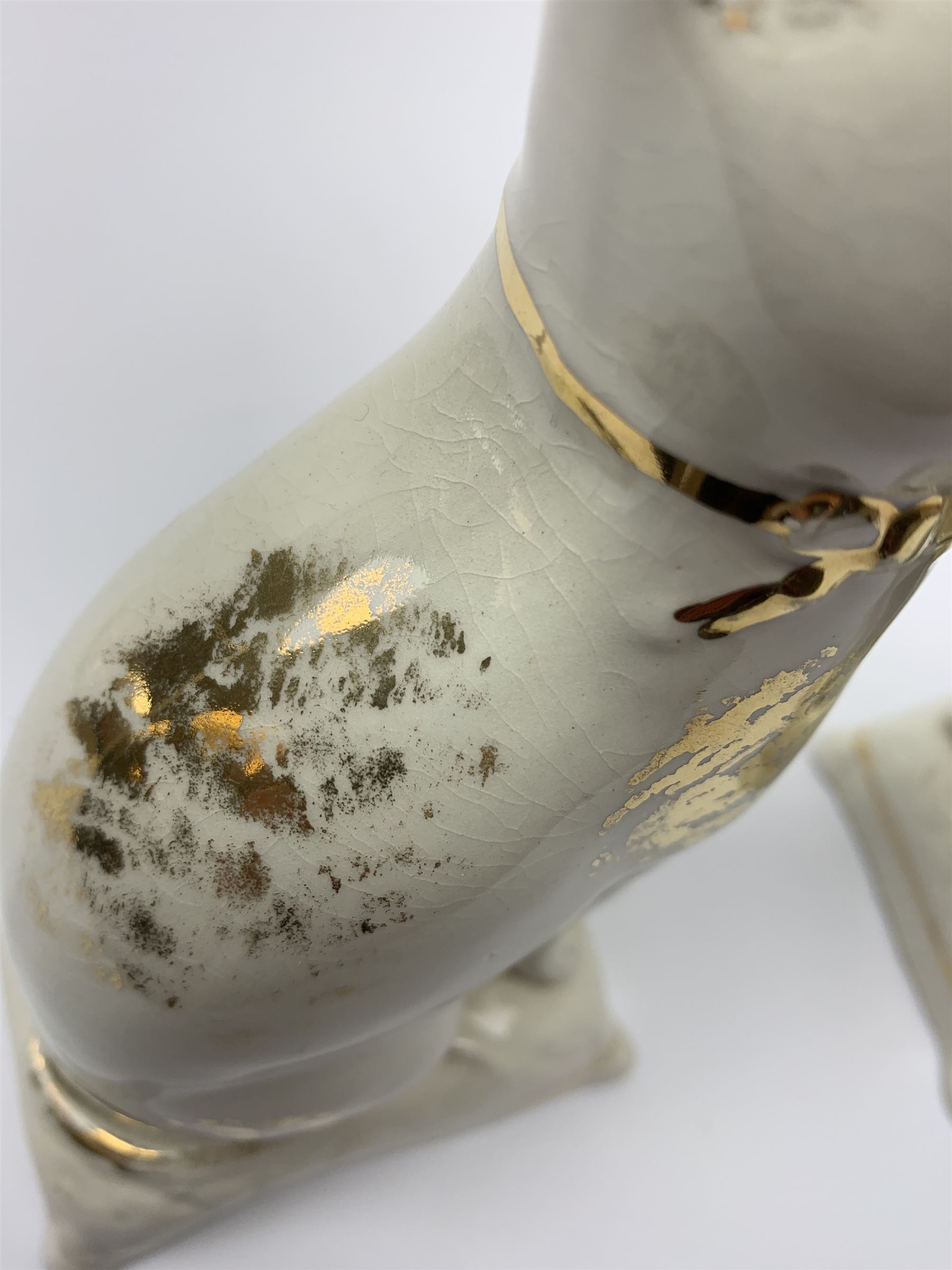 Pair of Victorian Staffordshire cats, modelled seated upon cushions, with gilt detail throughout, H18cm