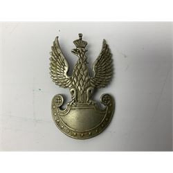 Three WW2 German visor cap badges comprising Police eagle, Political leaders eagle and Norwegian Quisling Party; all with fixings; and WW2 Polish visor cap badge (4)