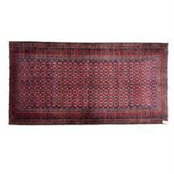 North East Persian Turkoman hand-knotted rug, indigo field densely decorated with an all-o...