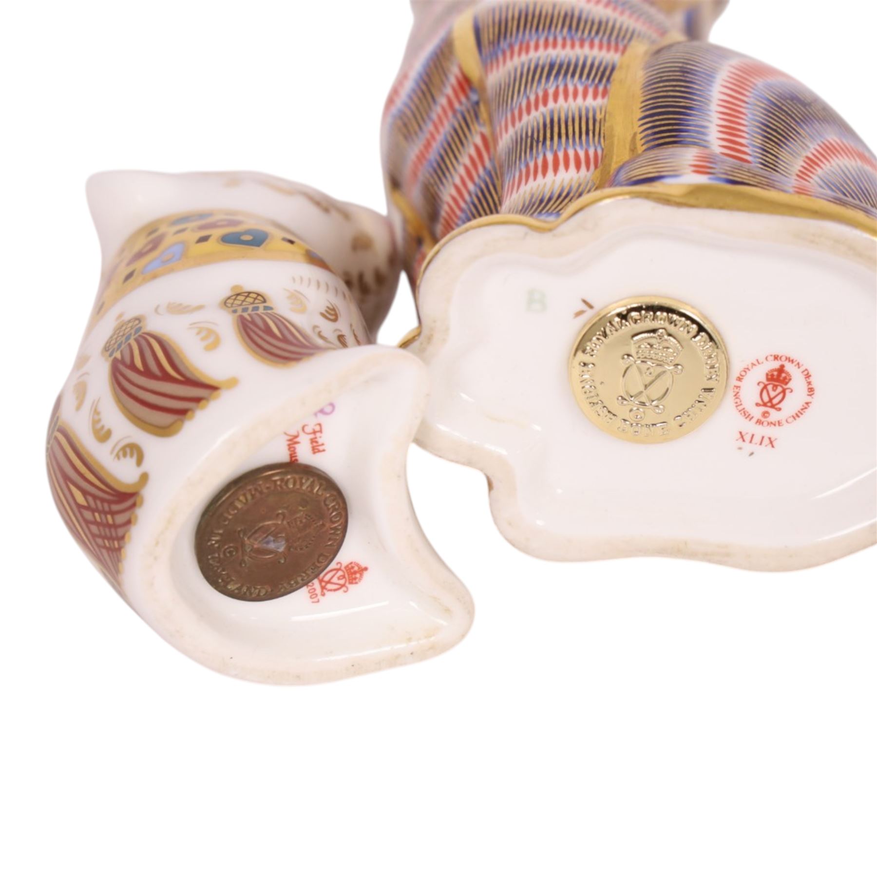 Three Royal Crown Derby paperweights, comprising Field Mouse gold stopper, Siamese cat gold stopper and seated cat gold stopper