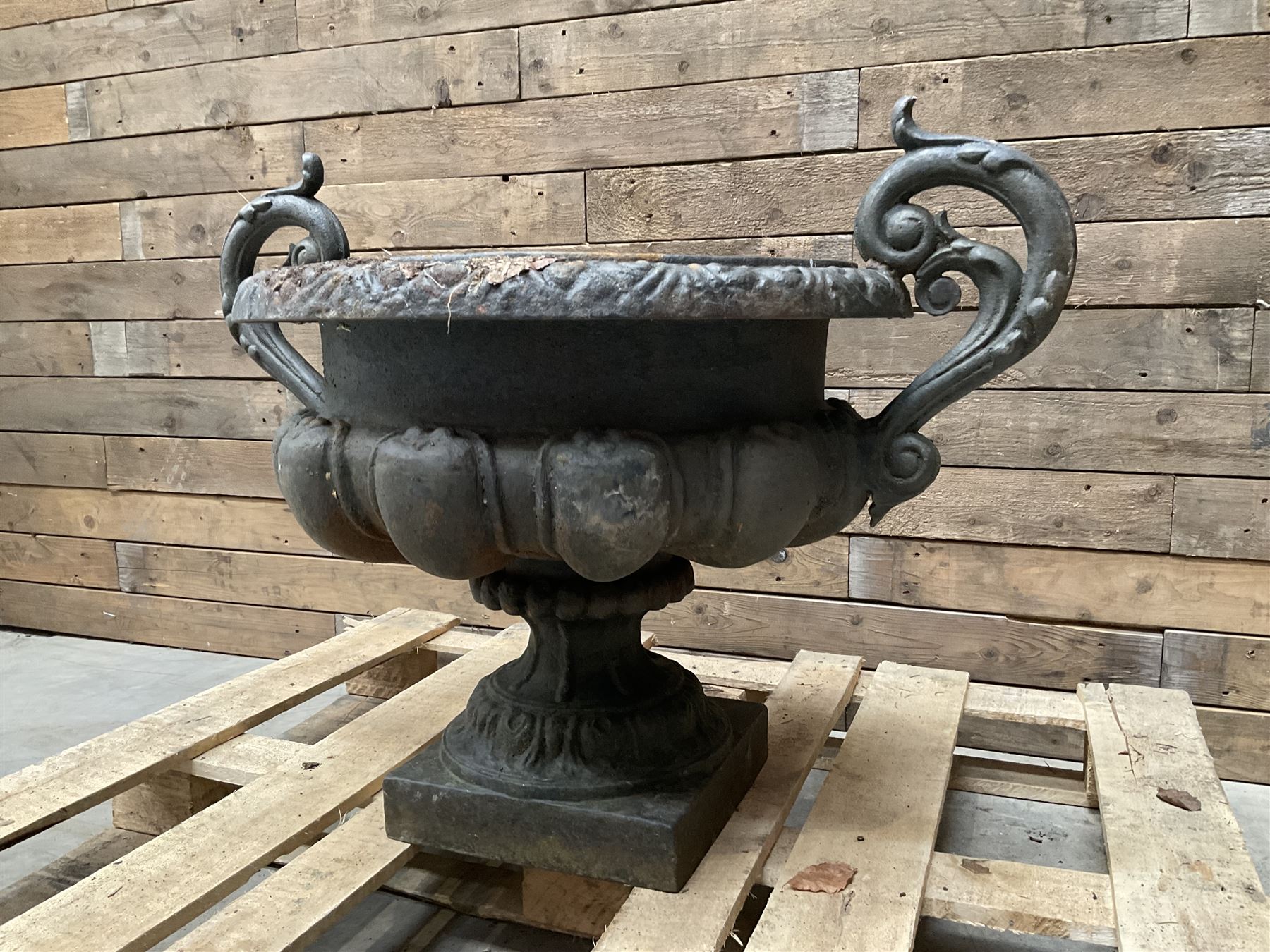 Victorian design ornate cast iron centrepiece urn, featuring two handles, raised on footed base