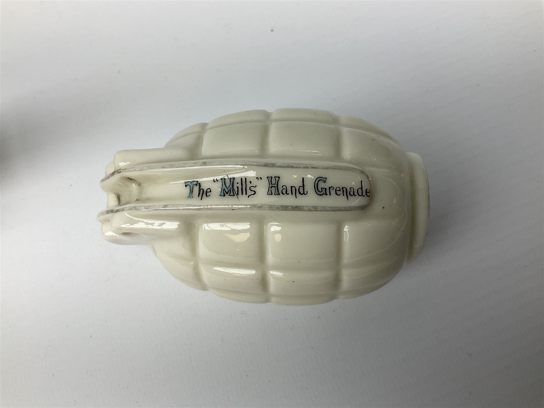 Three pieces of crested ware, comprising grenade detailed 'The Mills Hand Grenade' with Filey Crest, marked beneath Grafton China, a cannon with crest banner detailed 'Sterlini Oppidvm', marked beneath W H Goss, and a submarine with Tunbridge Wells crest, marked beneath Arcadian China 