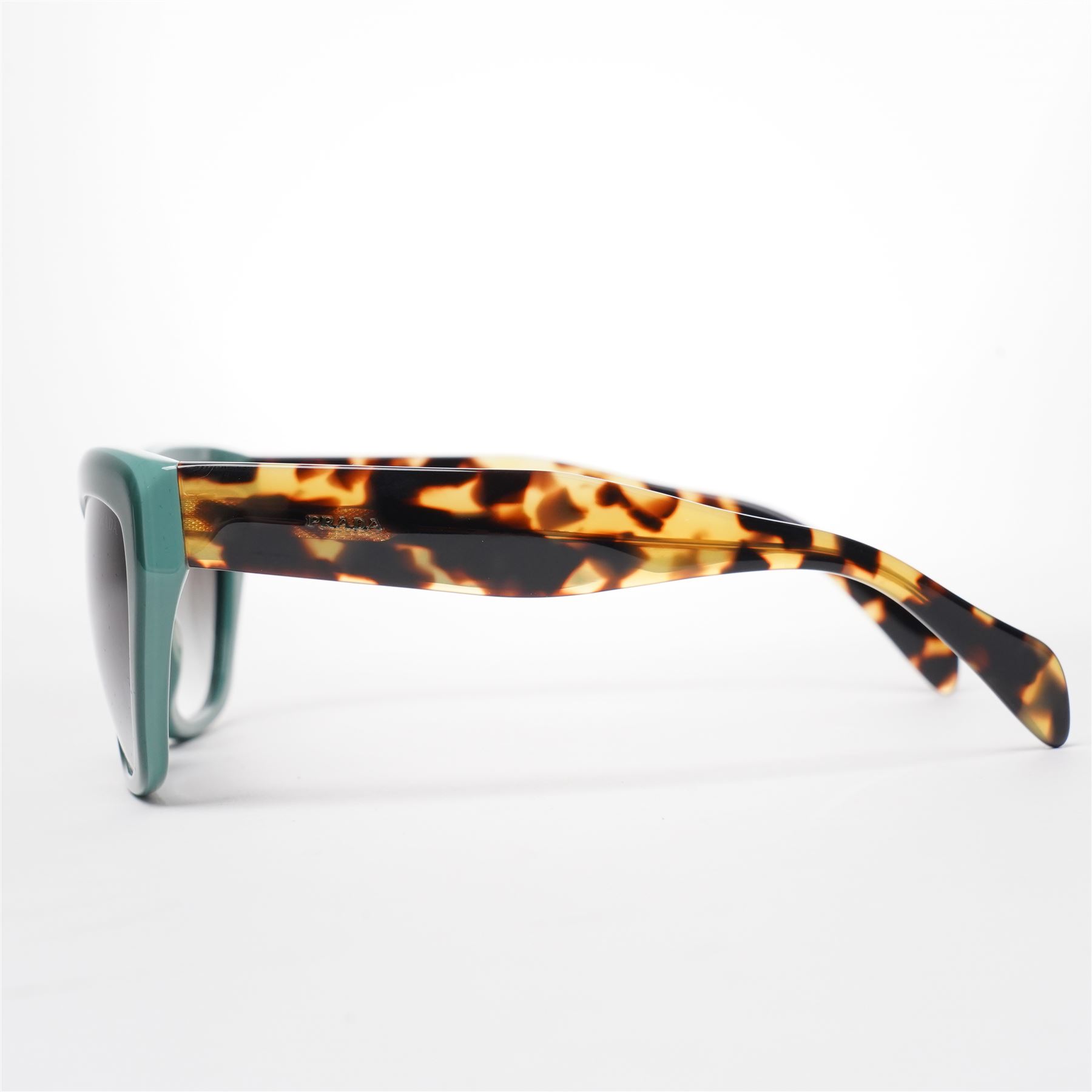 Prada - pair of cat-eye sunglasses, with green acetate frames and graduated tinted lenses, the arms in tortoiseshell finish with gold-tone ‘Prada’ branding, unused with original hard case and box