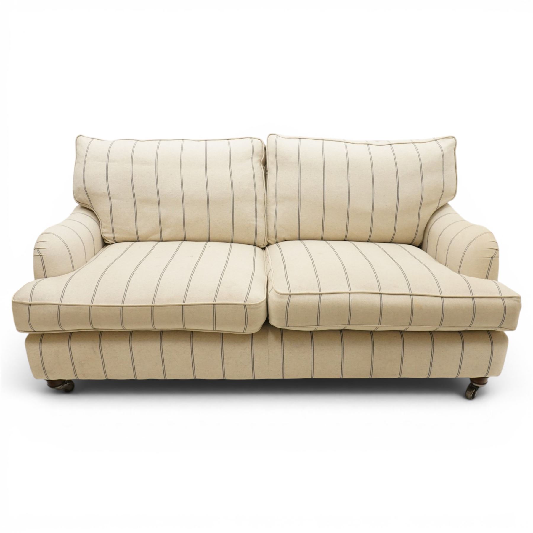 20th century Howard shape two seat sofa, deep seat sofa in cream and grep striped upholstery, raised on dark supports terminating in front castors 