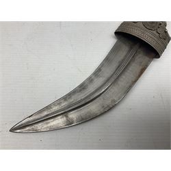 Omani Khanjar dagger, the 19cm curved blade with pronounced medial rib to either side, waisted hilt with dome shaped pommel and silver covered horn grip decorated with filigree bands, floral motifs and beadwork; in an intricately filigree decorated silver and leather scabbard with silver rings woven into the belt mount and fitted with original silver thread-work belt L34cm overall belt length 94cm