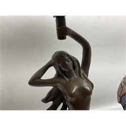 Tiffany style lamp in the form of a semi nude woman holding up a leaded lampshade together with a similar table lamp