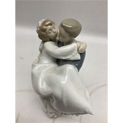 Royal Copenhagen figure group of couple kissing, together with to B & G figures and nine Nao figures 