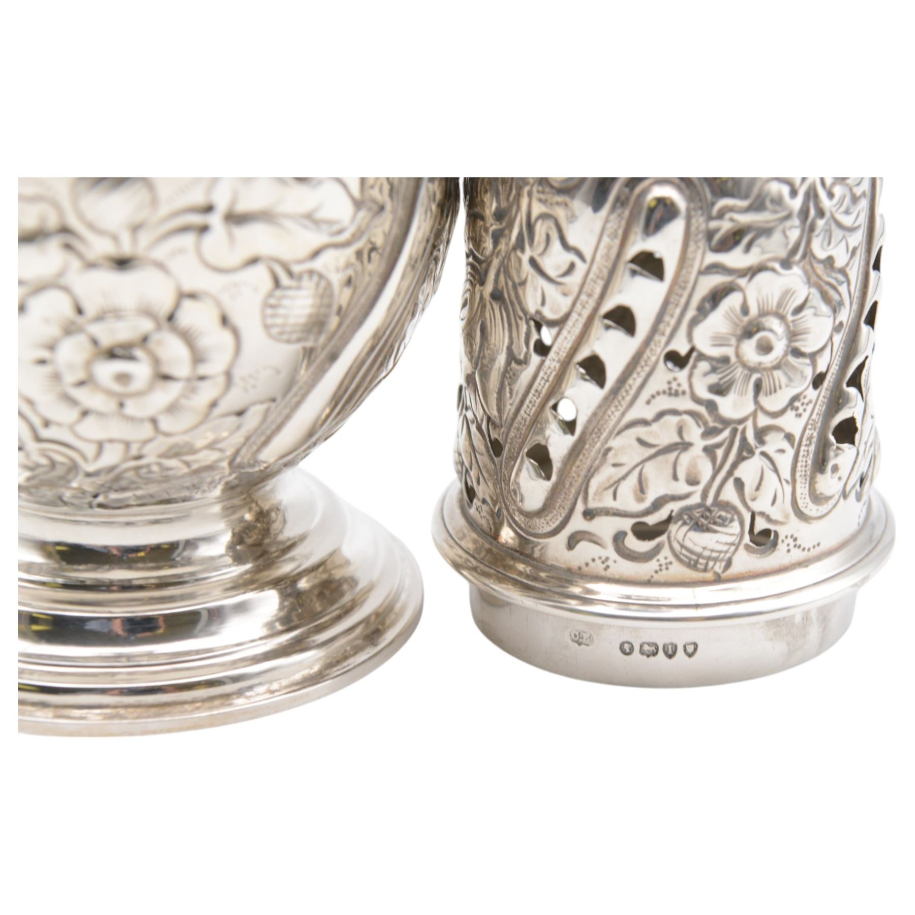 Victorian silver sugar caster, of typical waisted form with engraved and embossed floral and berry decoration, the removable pierced cover with urn finial, upon a circular stepped foot, hallmarked Charles Edwards, London 1884, H20.5cm