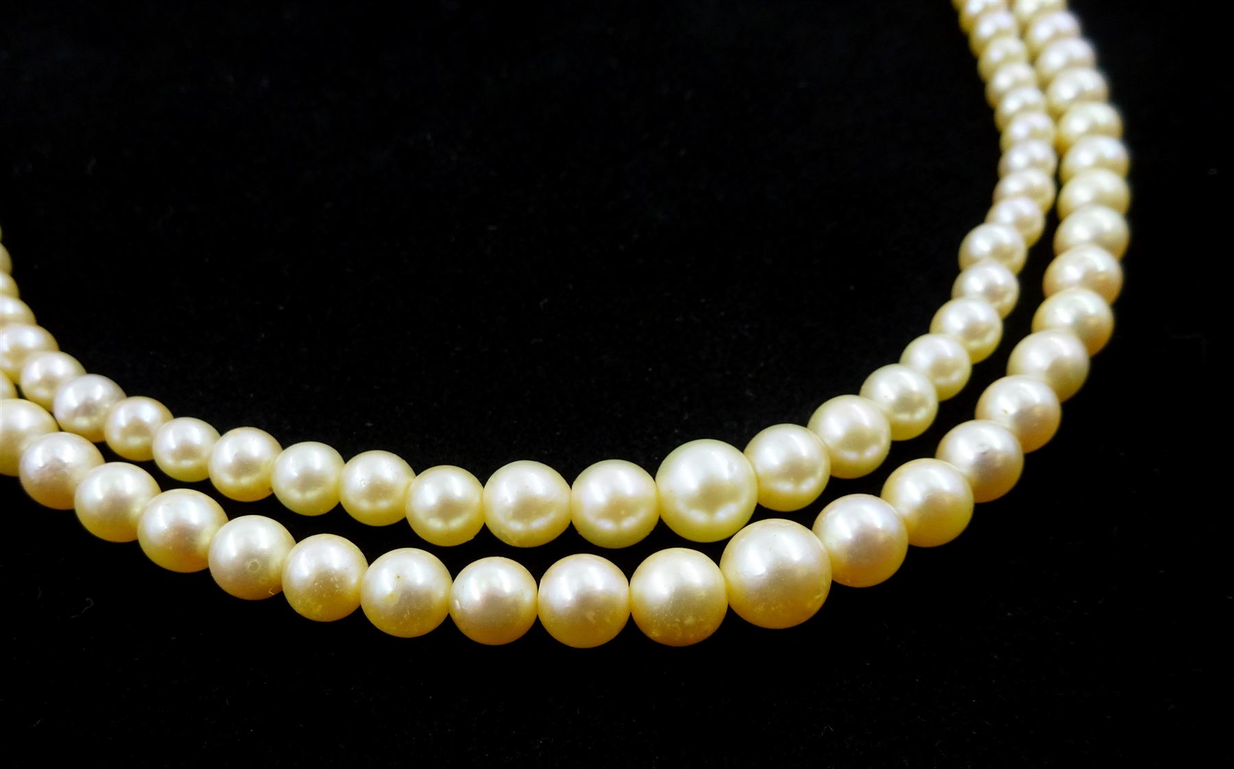 Double strand pearl necklace, graduating pearls between 3mm and 7.5mm, on 18ct white gold old cut diamond and opal milgrain set clasp, boxed