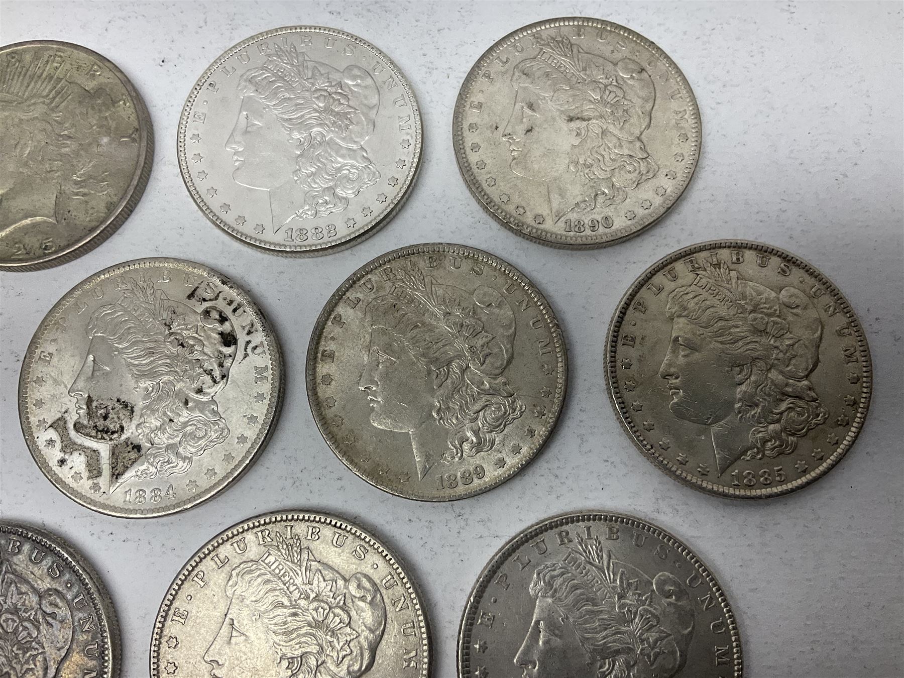 Eight United States of America silver Morgan dollar coins, dated 1882, 1884 O, 1884, 1885, two 1886, 1889, 1890 and a 1925 peace dollar